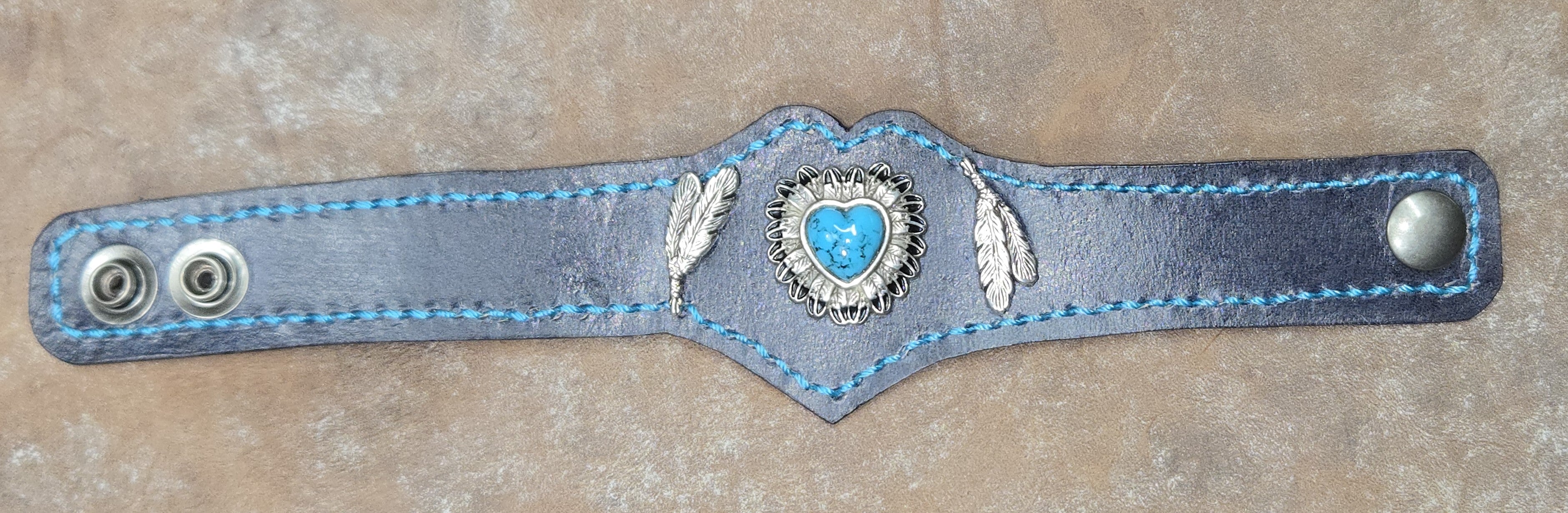 Turquoise heart w/feathers on black